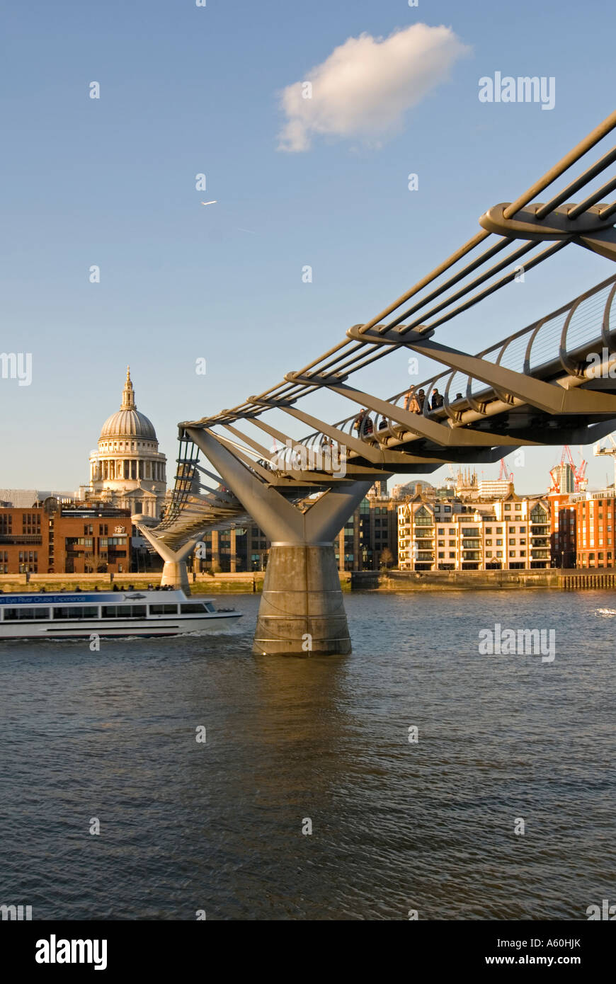 Vertical wide angle of the Millennium Bridge and St Paul's cathedral across the River Thames on a sunny evening. Stock Photo