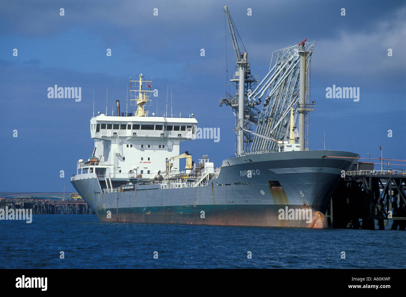 Navigo coastal oil tanker unloading at jetty, Milford Haven, Wales, UK Stock Photo