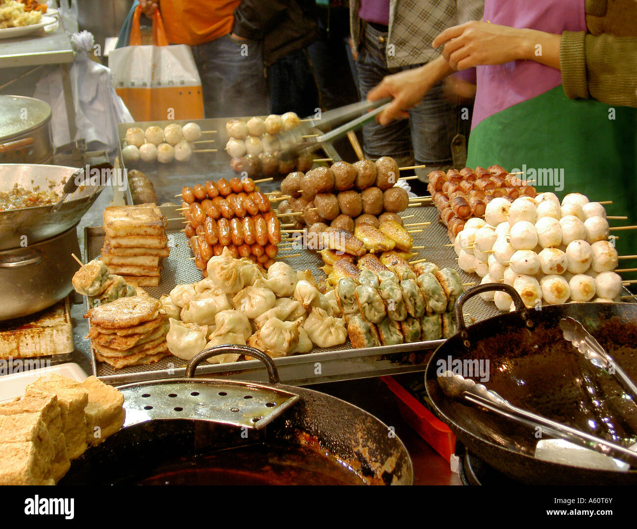 Kebabs and hot snack food for sale on night street stall in Mong Kok