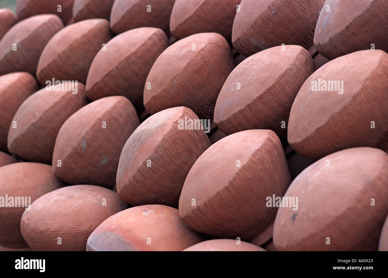Pile of terracotta ceramic bowls for sale at market Mandalay Burma