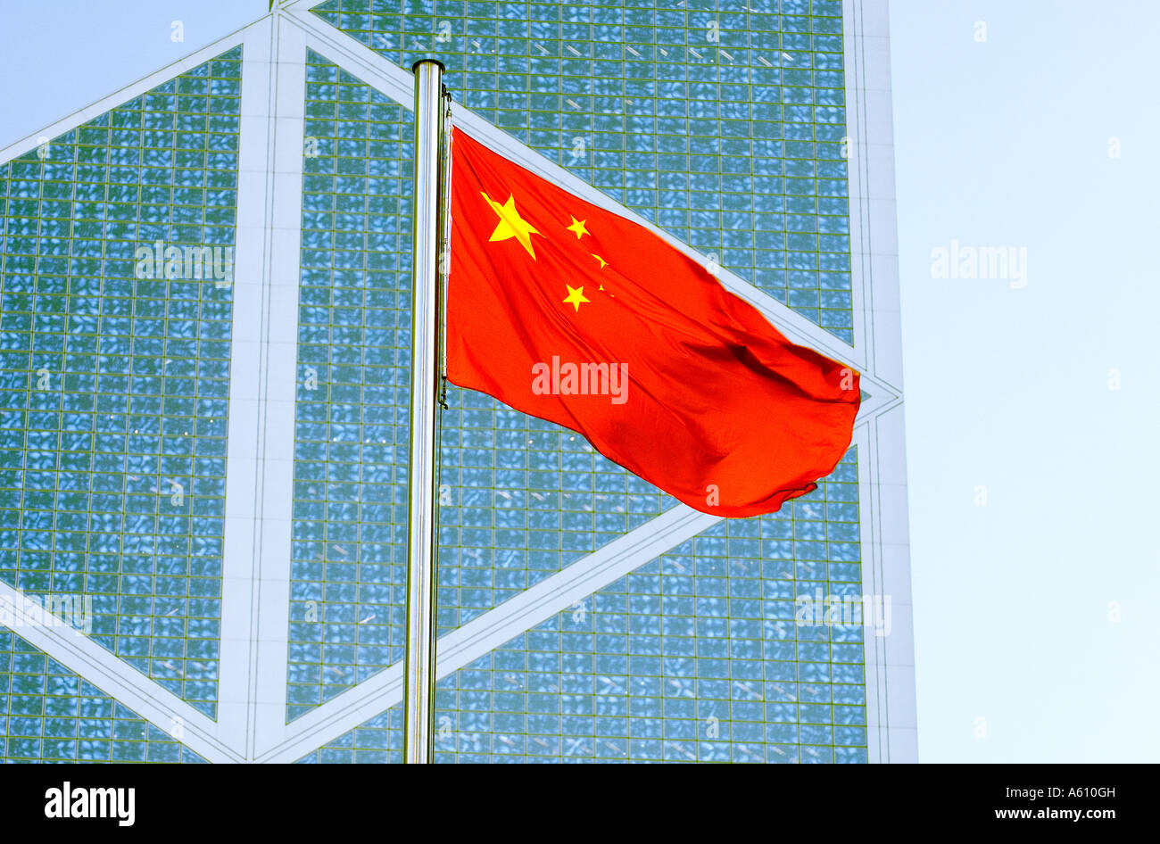 Chinese flag against windows of ultra modern design Bank of China high rise office block. Central District, Hong Kong Island Stock Photo