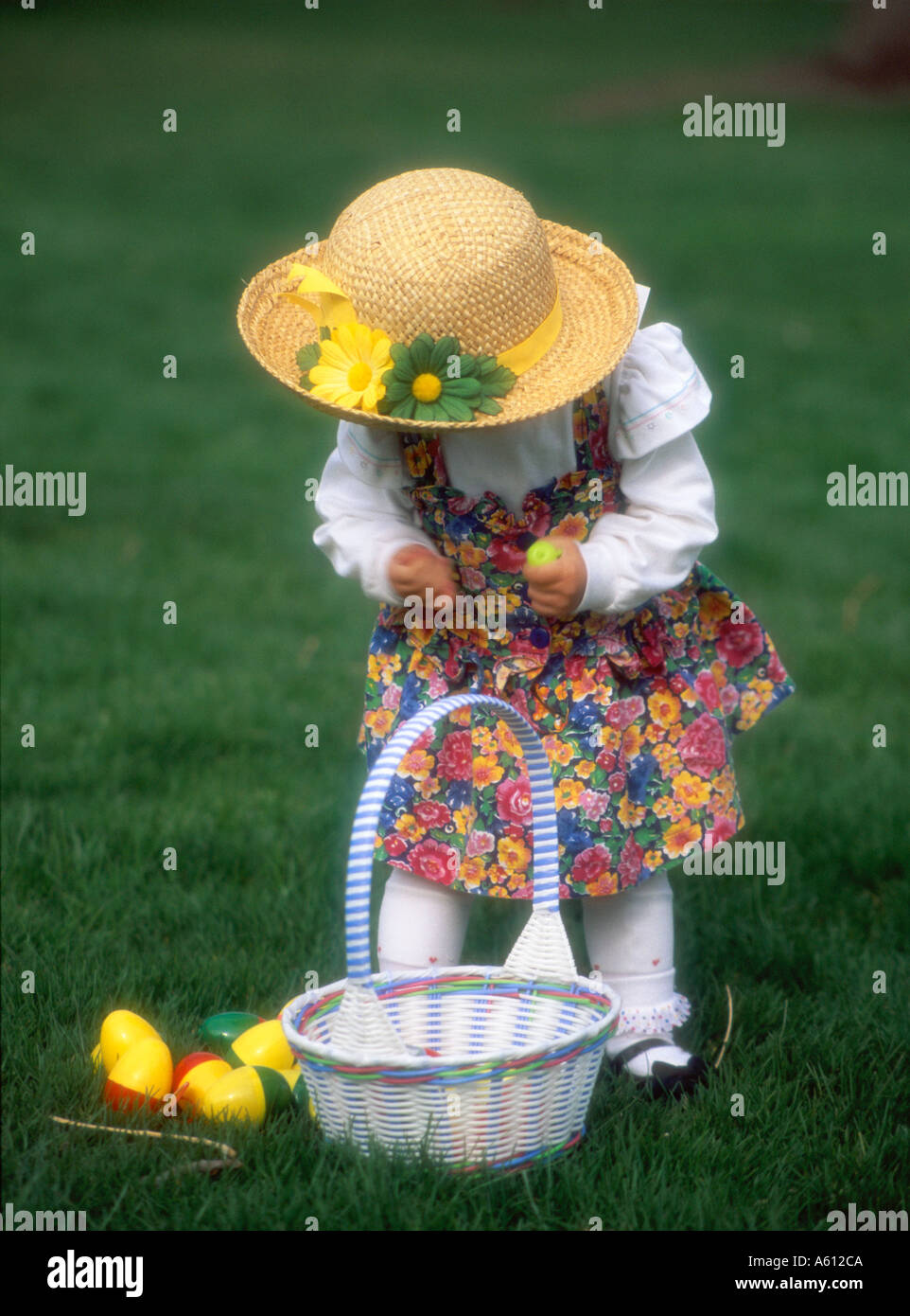 Little girl picking up Easter eggs Stock Photo Alamy