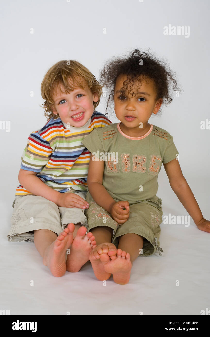 A Young Blond Boy And A Beautiful Mixed Race Little Girl Cuddle Up
