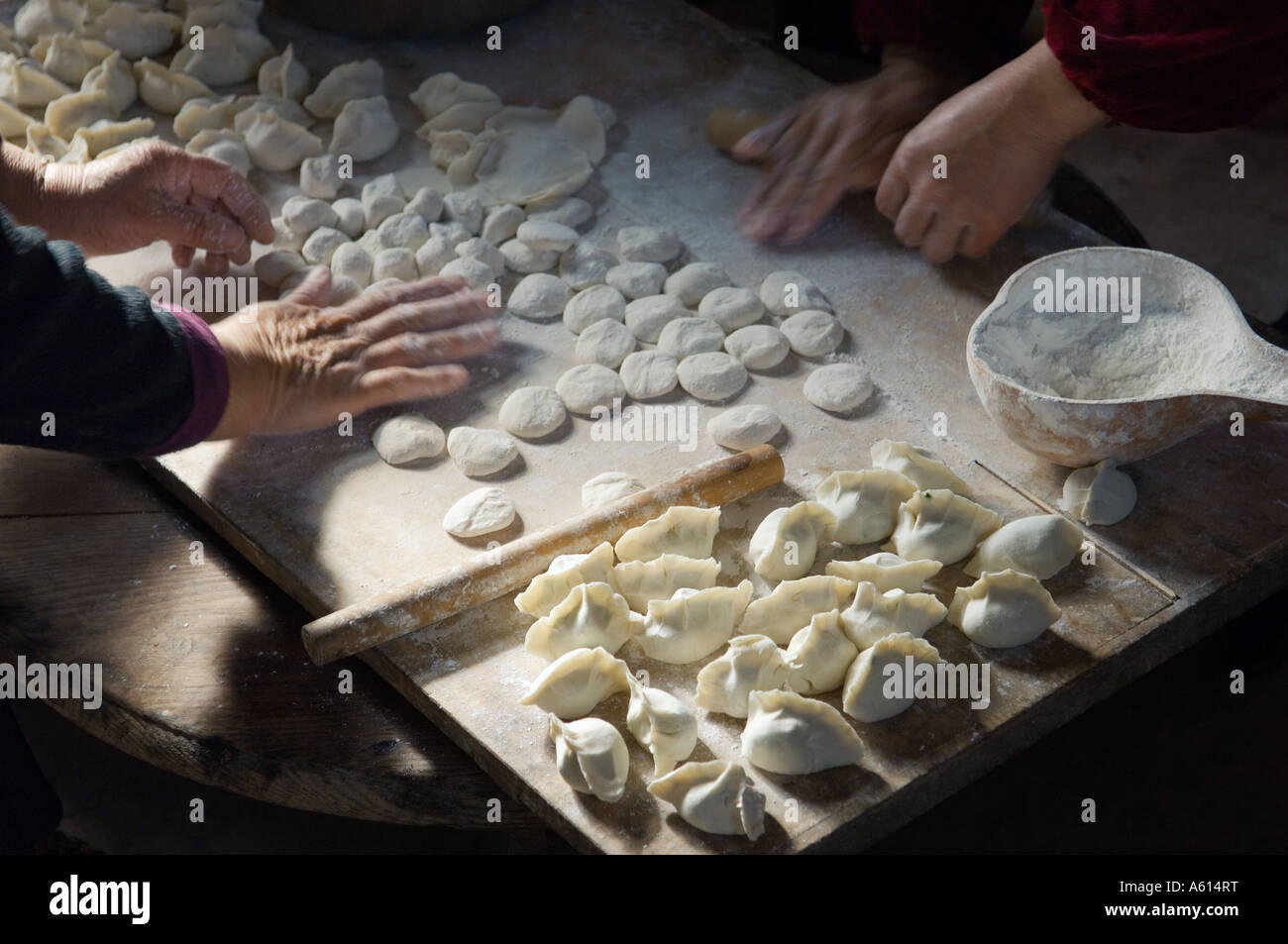 Making traditional dim sum Chinese dumplings. Meat dough pastry and spring onions cuisine. Farm kitchen Shandong Province, China Stock Photo