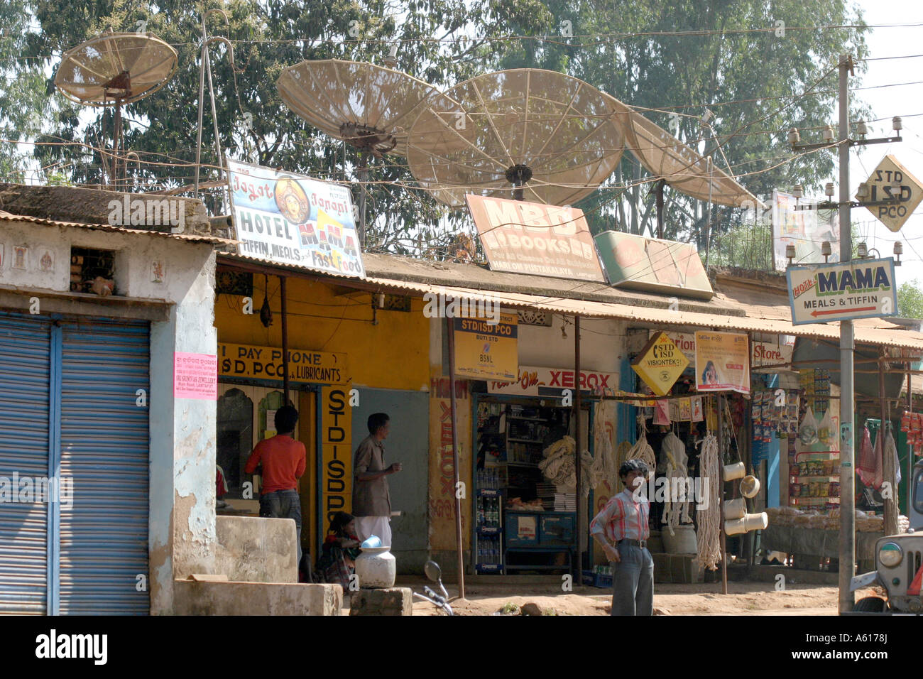 Internet and  TV ariels on the  roofs of  shops in a remote  tribal  area village in Orissa India Stock Photo