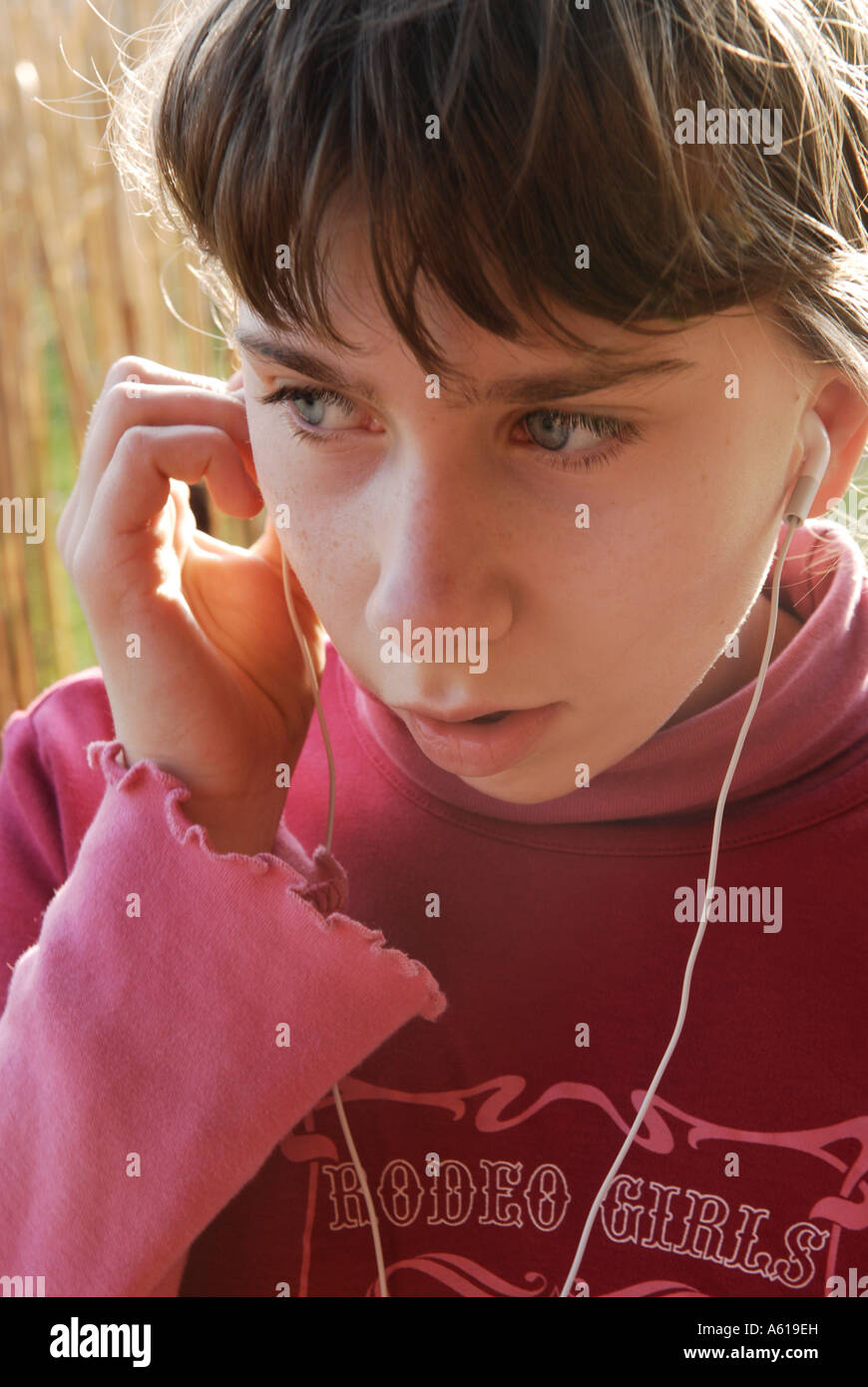 Girl hears music with the Apple IPod shuffle2 MP3 Player Stock Photo