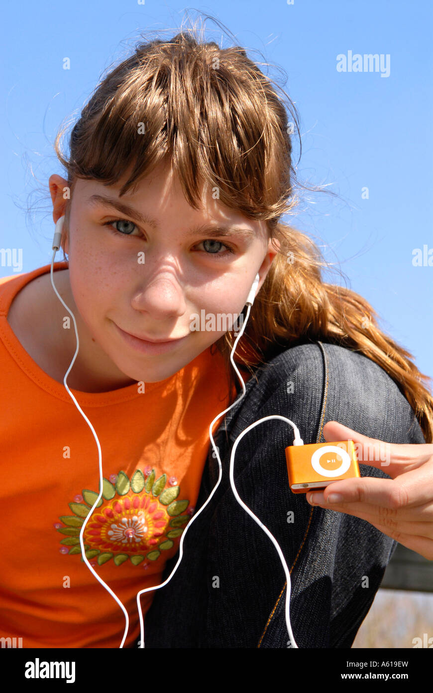 Girl hears music with the Apple IPod shuffle2 MP3 Player Stock Photo