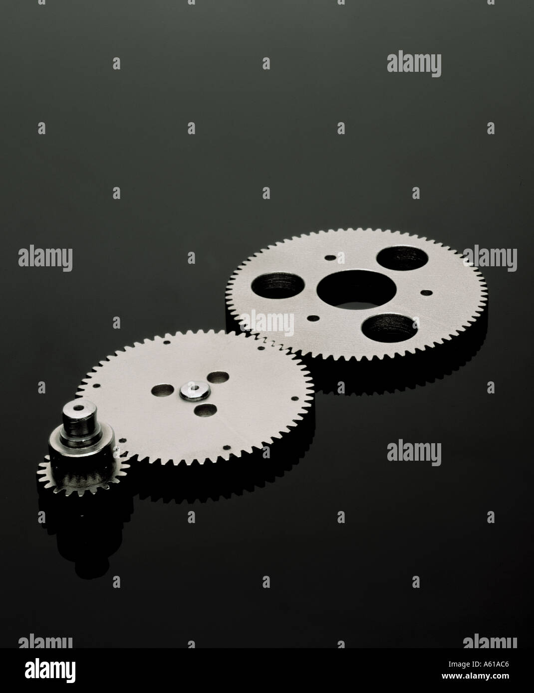 Synchronized gears on black plexiglass connected Stock Photo Alamy