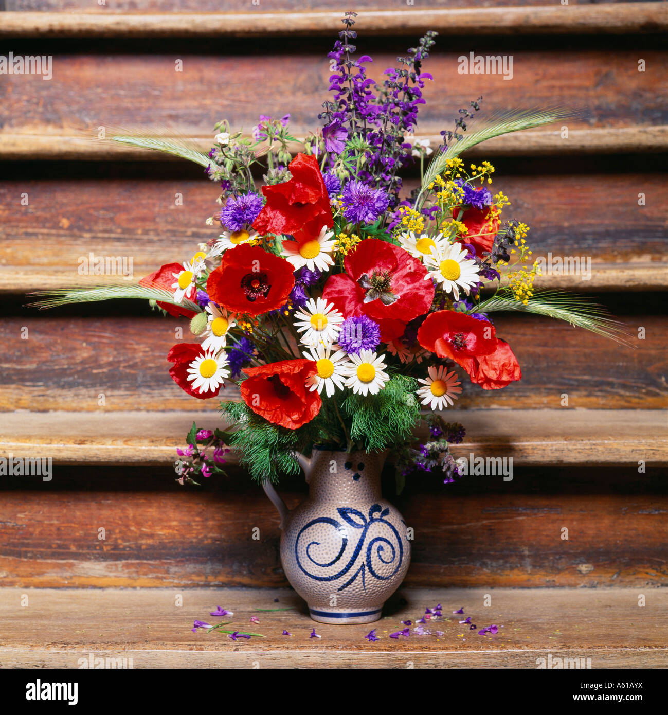 Summery bouquet of flowers on an old staircase Stock Photo