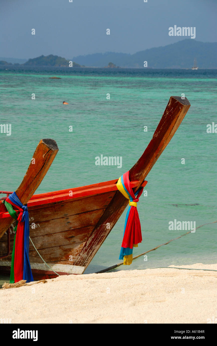 Decorated bow of two longtail boats at white sandy beach Koh Lipe Thailand Stock Photo