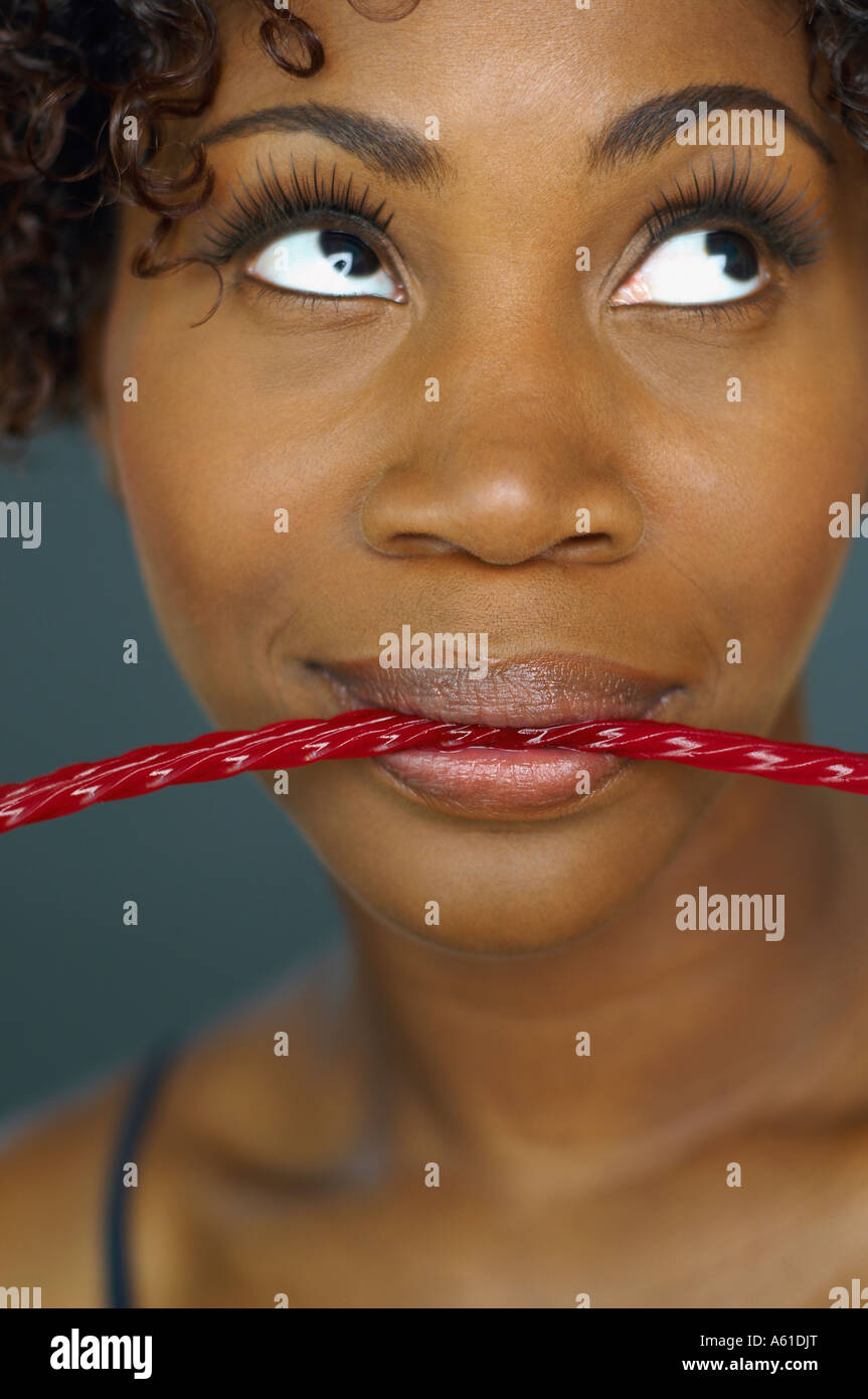 Close up of African woman eating licorice Stock Photo Alamy