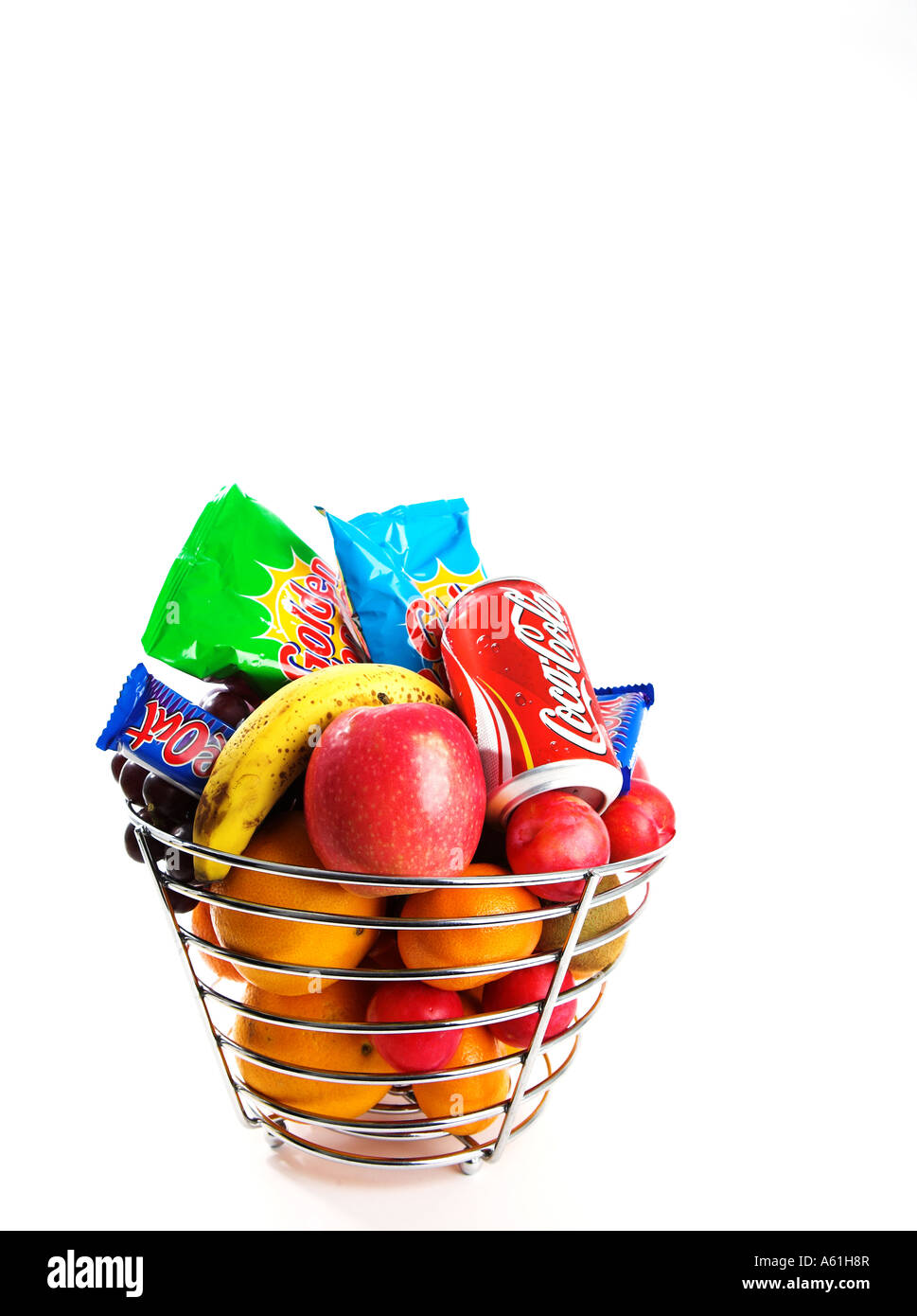 A silver fruit basket containing healthy fruit and unhealthy crisps