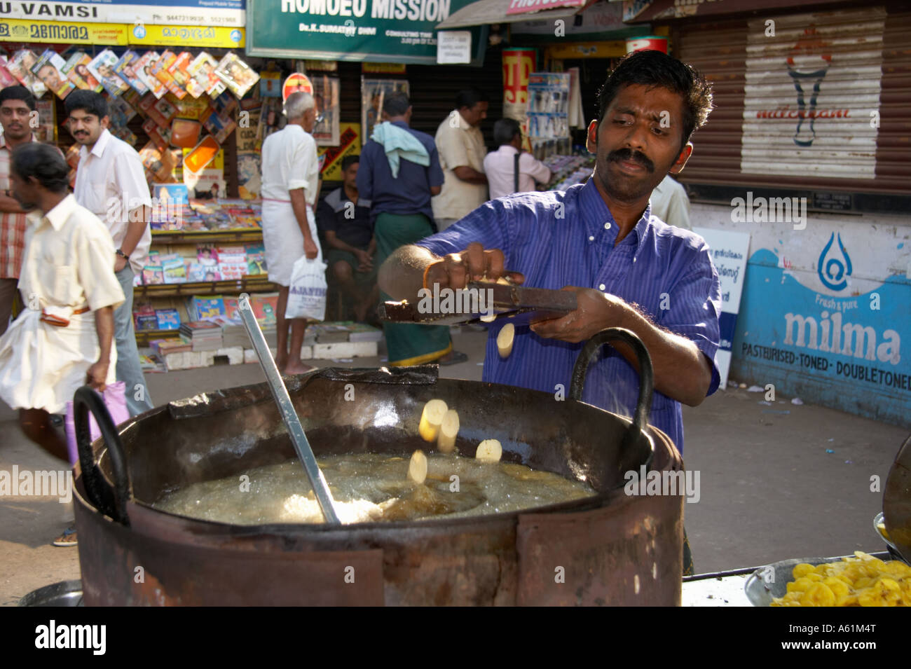 Man Slicing Bananas Into A Deep Fat Fryer To Make Banana Chips Thiruvananthapuram Trivandrum Kerala India Stock Photo Alamy
