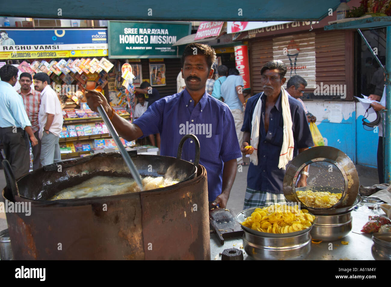 Man making banana chips in a deep fat fryer Thiruvananthapuram Trivandrum Kerala India Stock