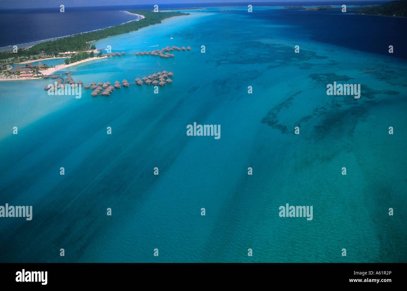 Aerial of the green water and clear blue colors of the islands of Bora