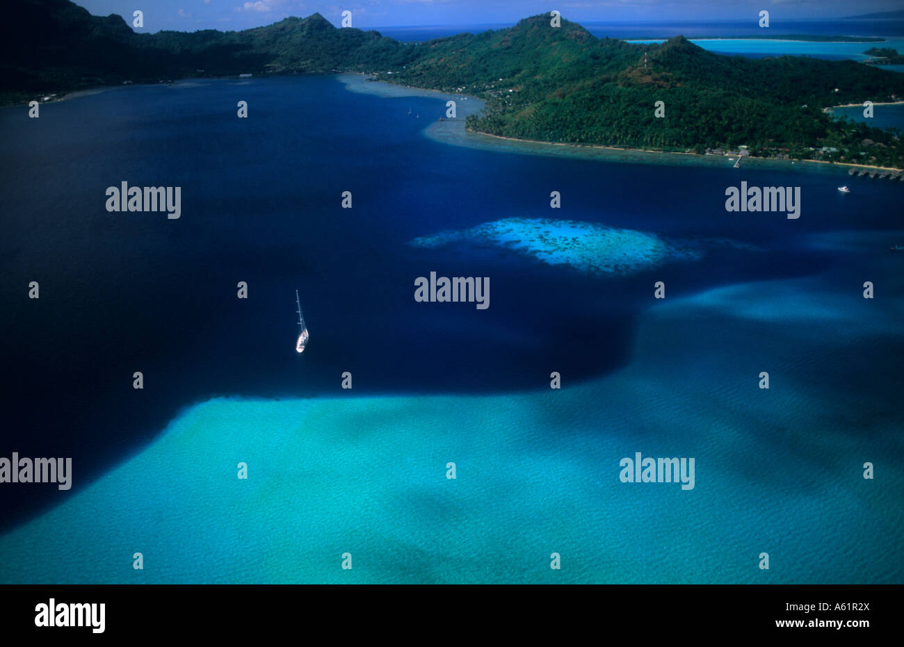 Aerial of the green water and clear blue colors of the islands of Bora