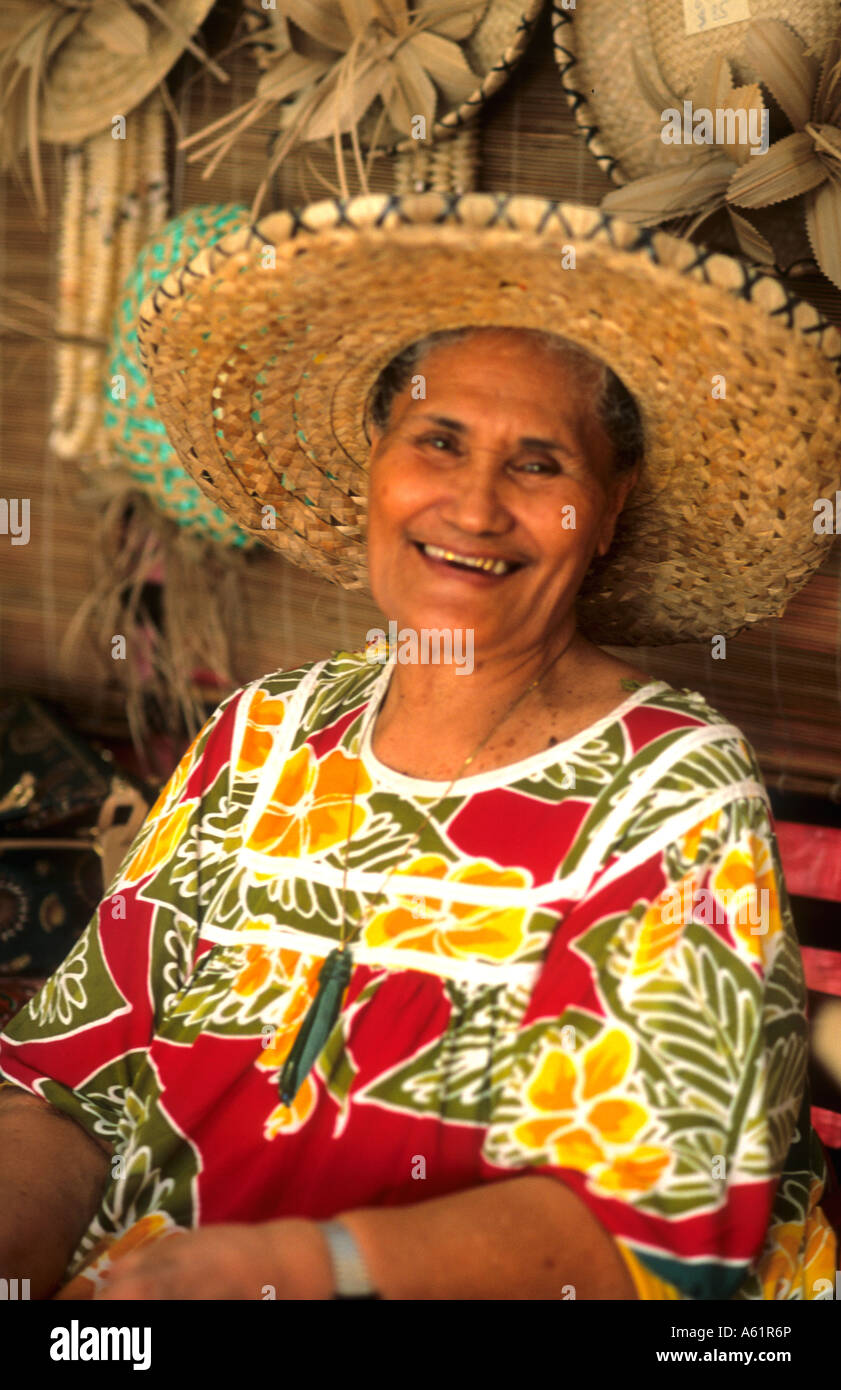 Native woman in colorful local dress in Tahiti capital of Plage de Surf Papeete in French Polynesia Stock Photo