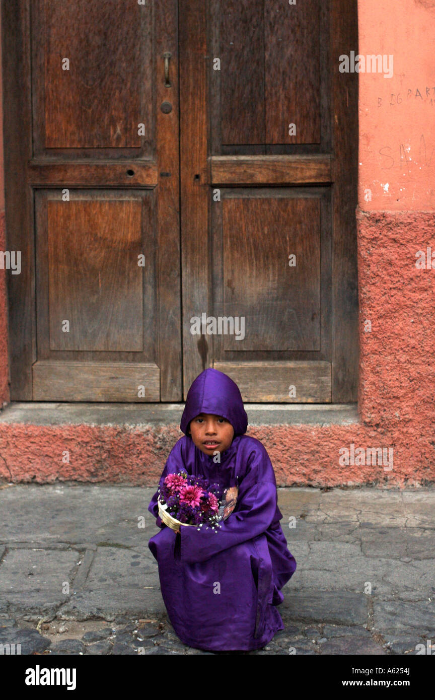 An unidentified boy sits outside a building following the youth precession during Antigua's holy week celebrations. Stock Photo