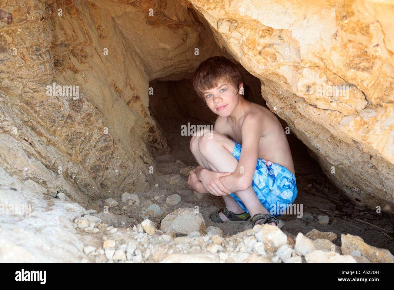 portrait-of-a-young-boy-hiding-in-a-cave