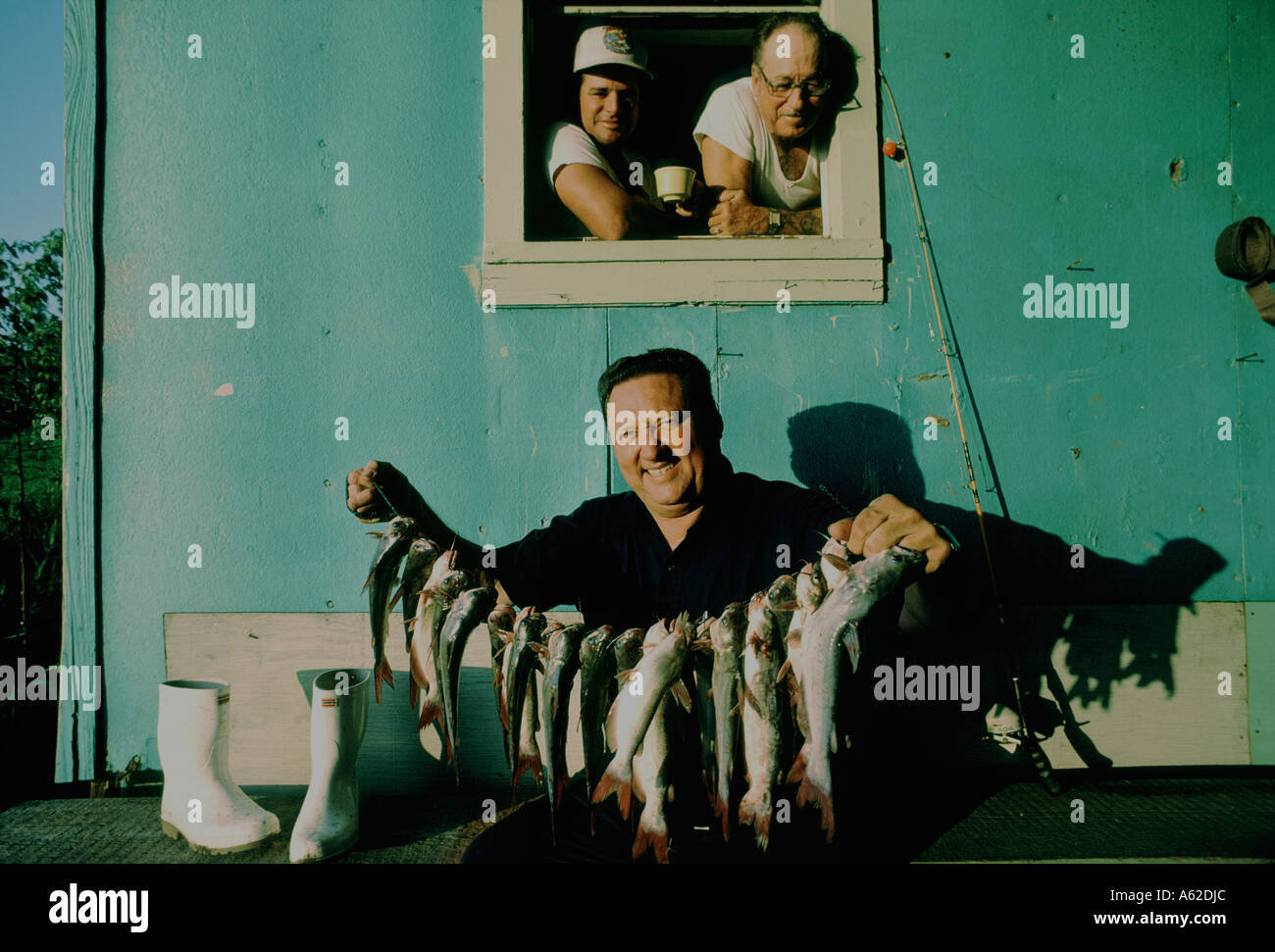 A Louisiana man shows off his string of catfish Stock Photo - Alamy