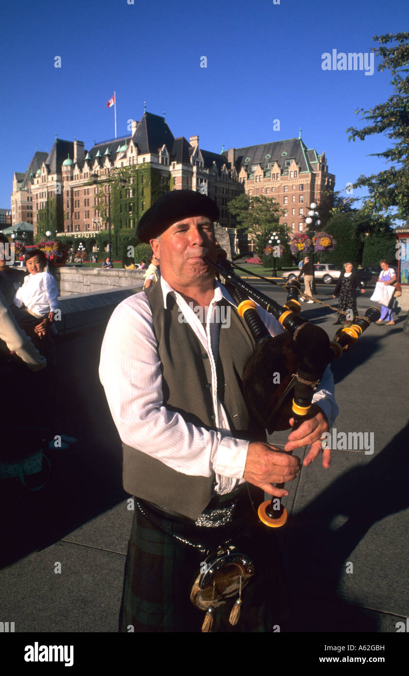 Local Scotish bag pipe player in front of the famous Empress Hotel in beautiful Victoris British Columbia Canada Stock Photo