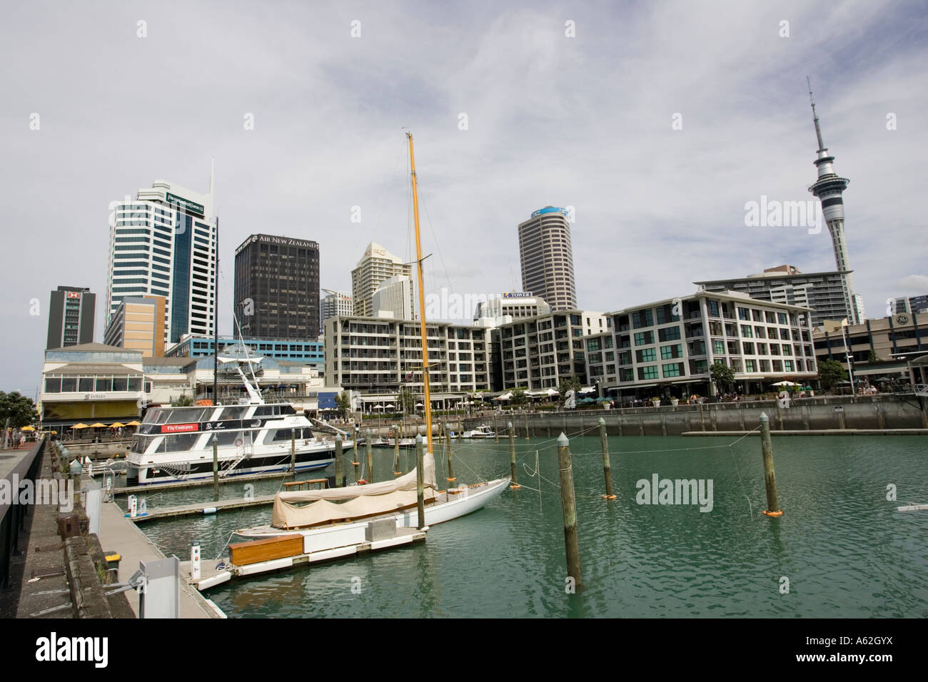 Pleasure boats moored in inner harbour and high rise city skyline ...