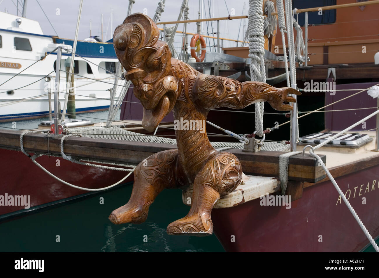 Maori traditional wood carving on prow of sailing boat near Auckland New Zealand Stock Photo