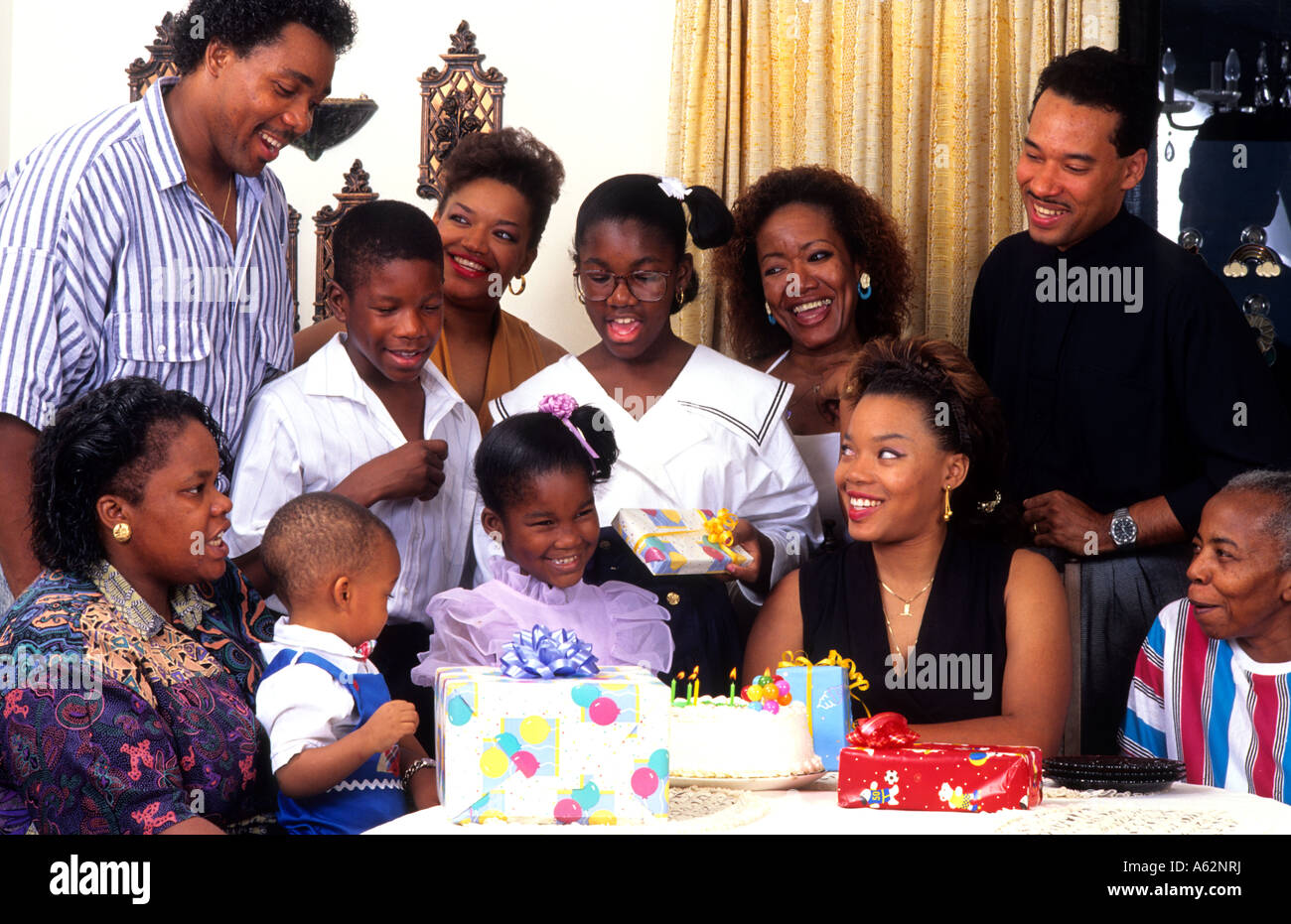 Large four generation family celebrating birthday party at home together  with loving caring around table with presents singing Stock Photo - Alamy