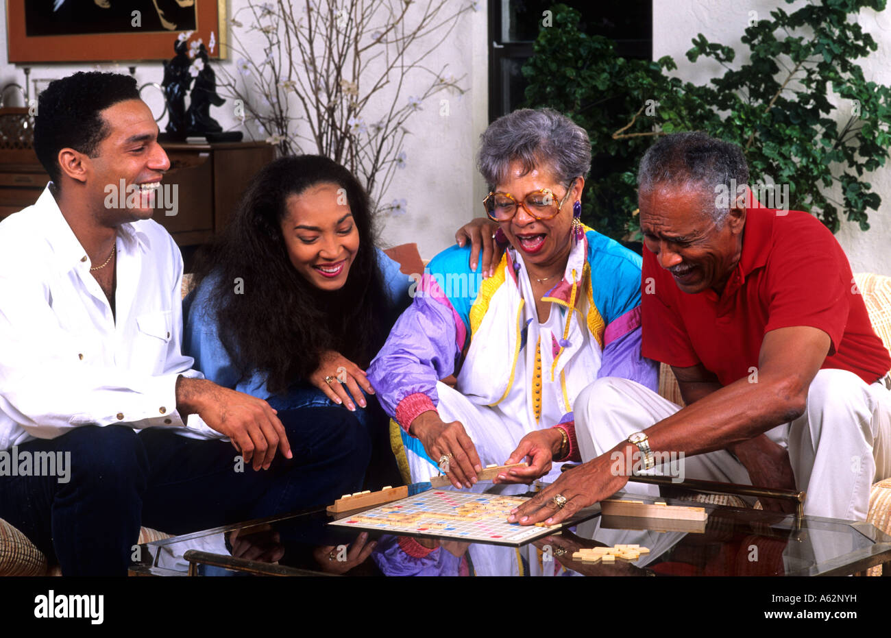 Three generation black african american family playing board games at