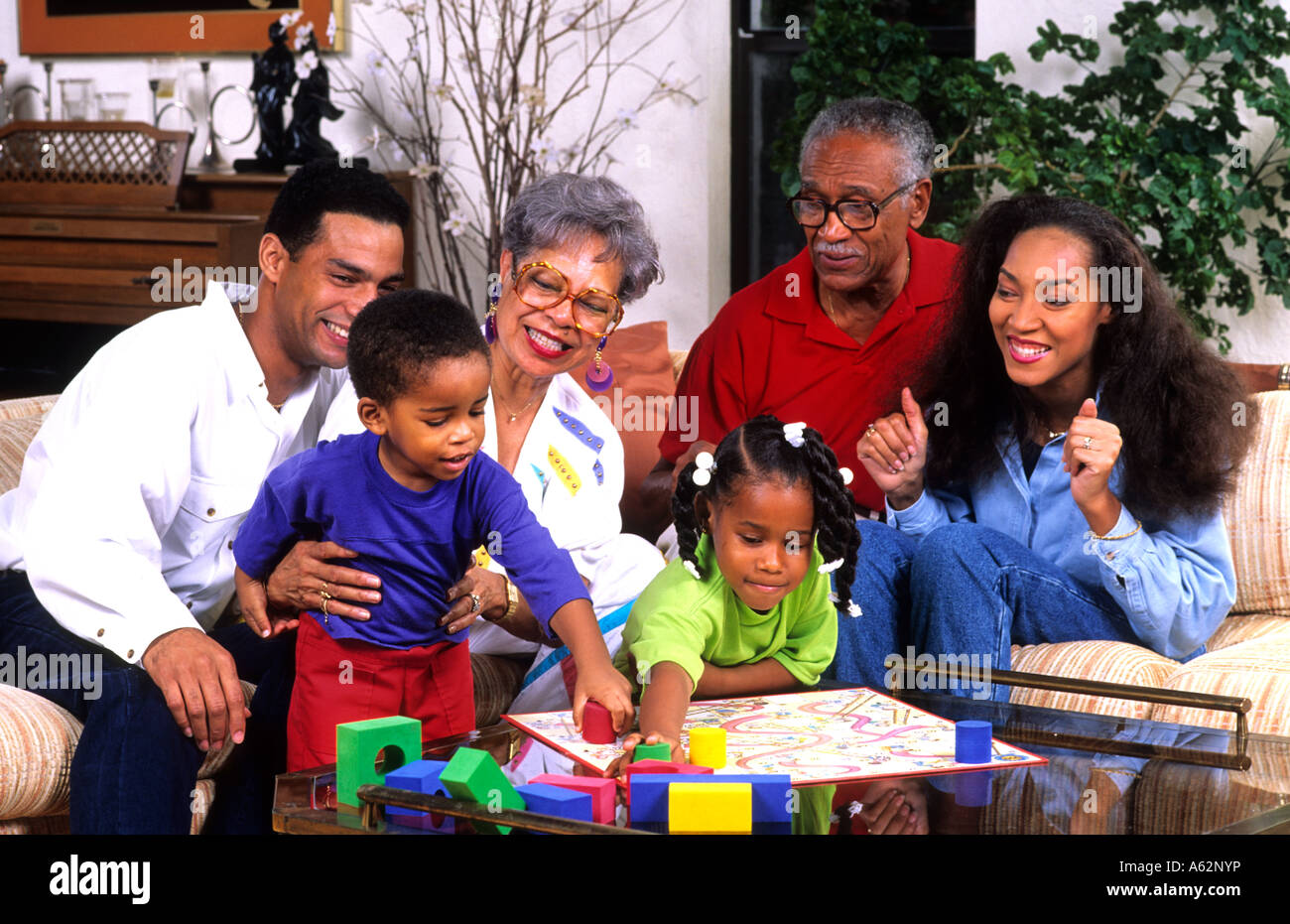 Three generation black african american family playing board games at home together having fun and laughing Stock Photo