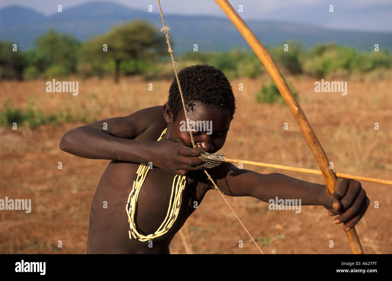 Hadza boy hunting with bow and arrow Lake Eyasi Tanzania Small tribe of