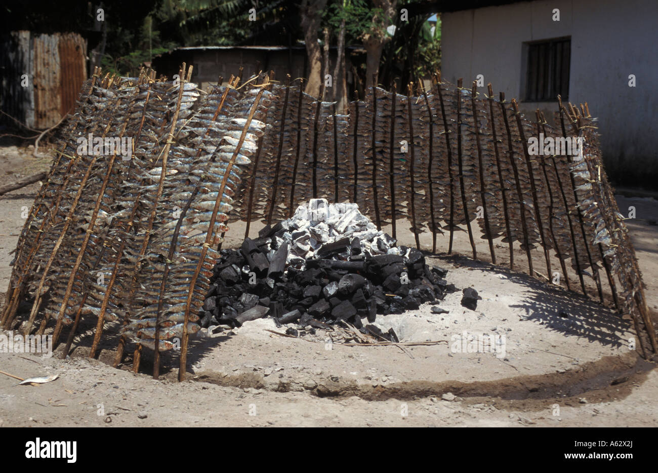 Fish Smoking Around A Fire Kilwa Kivinje South Coast Tanzania Stock 