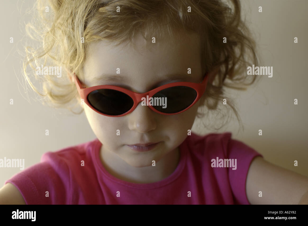 Little blond girl wearing sunglasses. Stock Photo