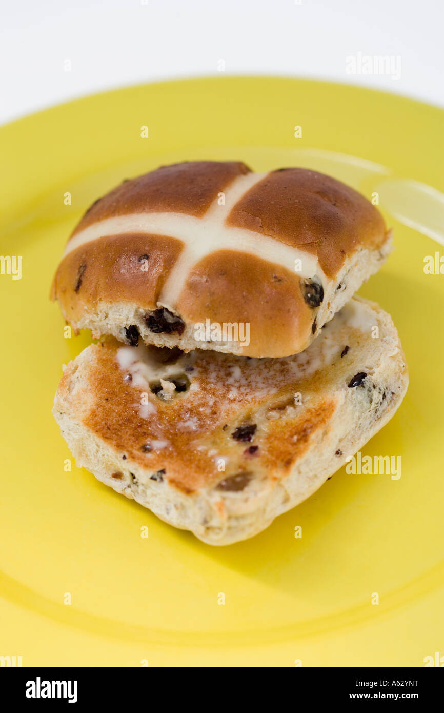 Toasted Hot Cross Bun on a yellow plate Stock Photo Alamy