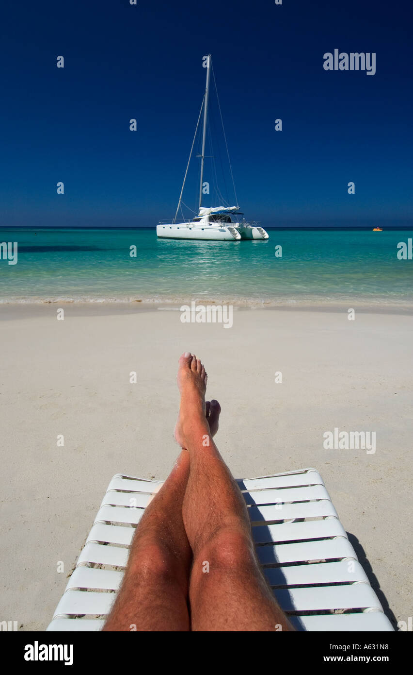 Man reclining in beach chair West Bay beach Roatan Honduras Stock Photo