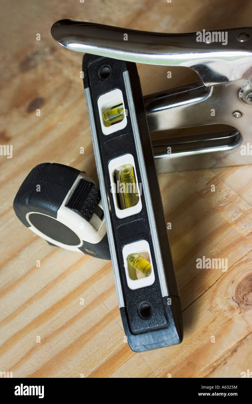 Tape measure staple gun and level Stock Photo Alamy