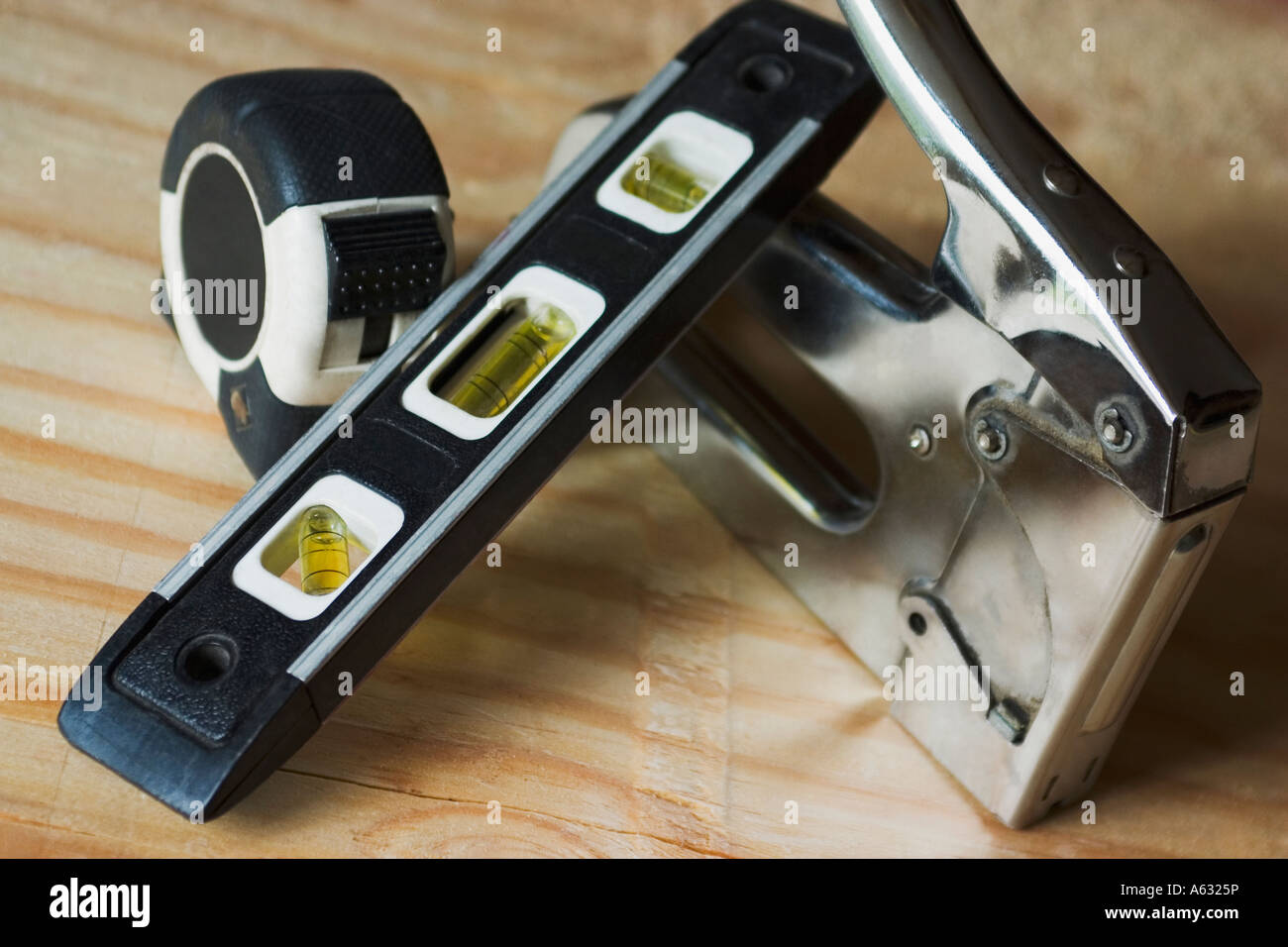 Tape measure staple gun and level Stock Photo Alamy