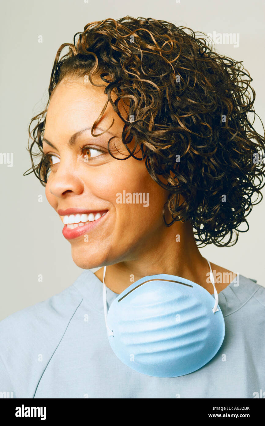 Close-up of a female nurse smiling and wearing scrubs Stock Photo