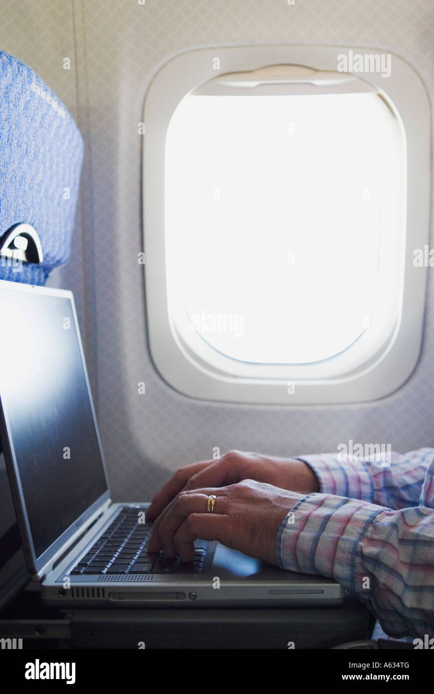 Man with laptop on airplane Stock Photo - Alamy