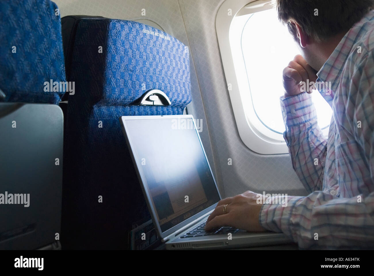 Man with laptop on airplane Stock Photo Alamy