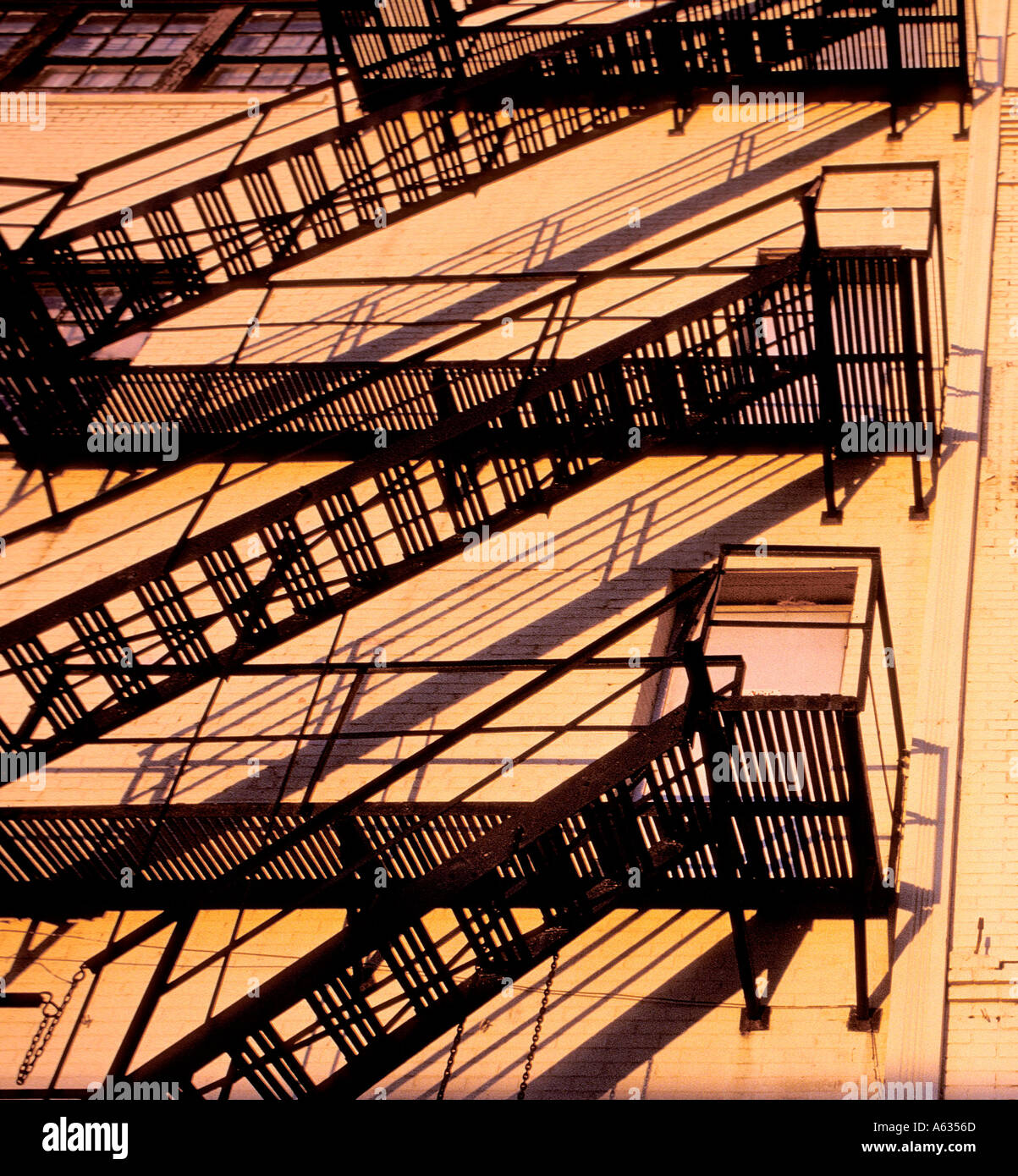 Fire escapes on building exterior in late afternoon light Stock Photo