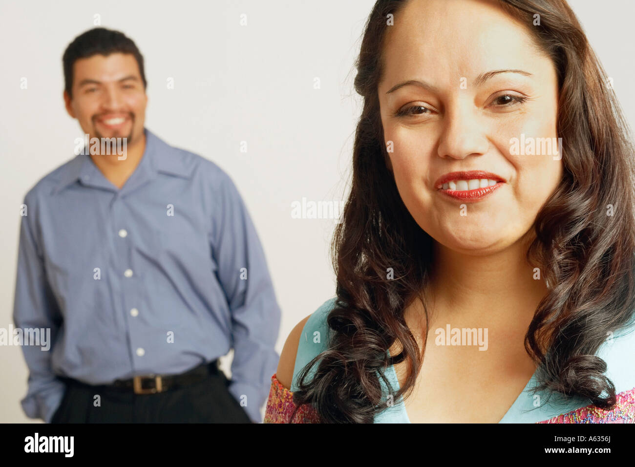 Portrait of a mid adult woman smiling with a mid adult man standing in ...