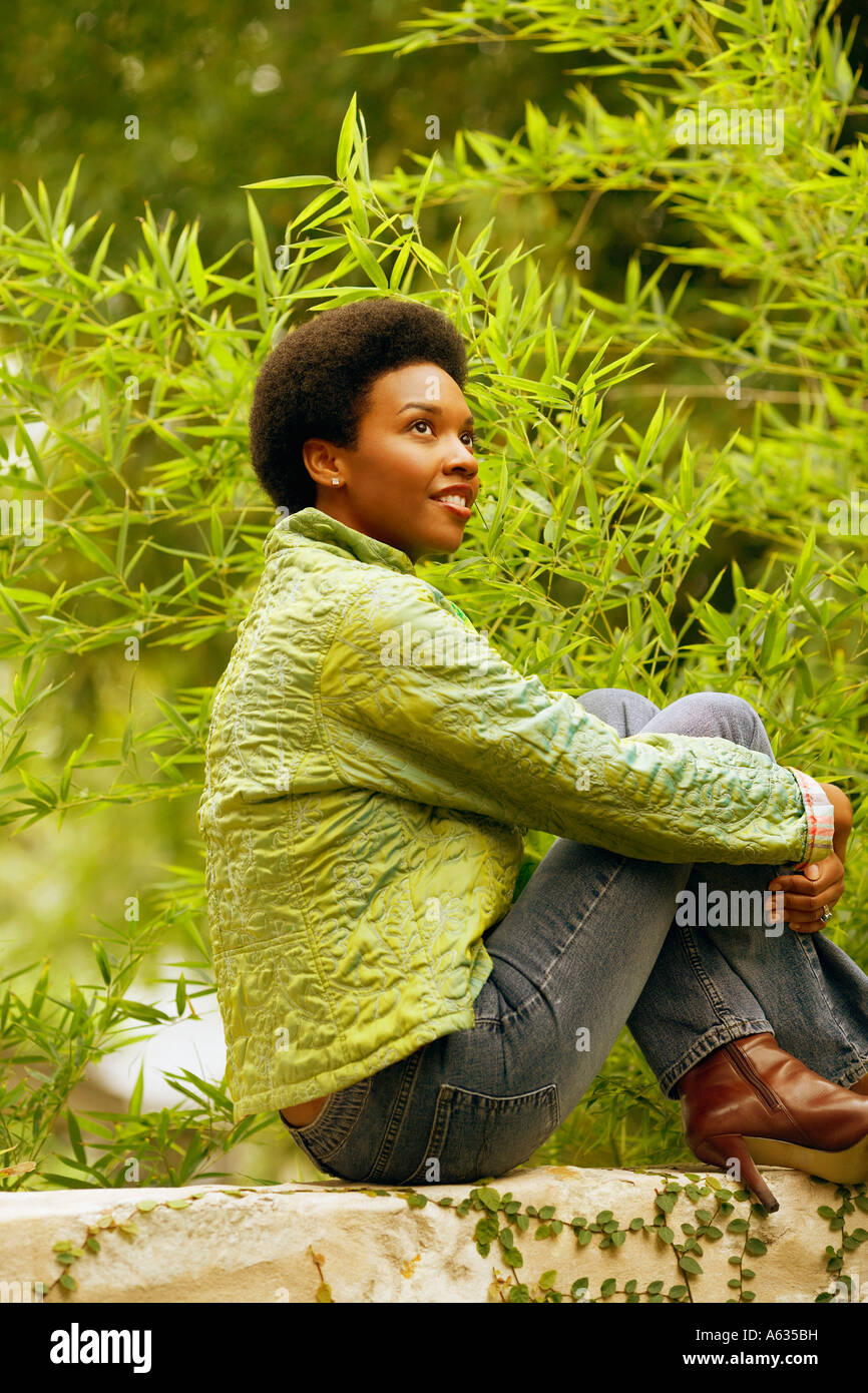 African woman sitting alone side view hi-res stock photography and ...
