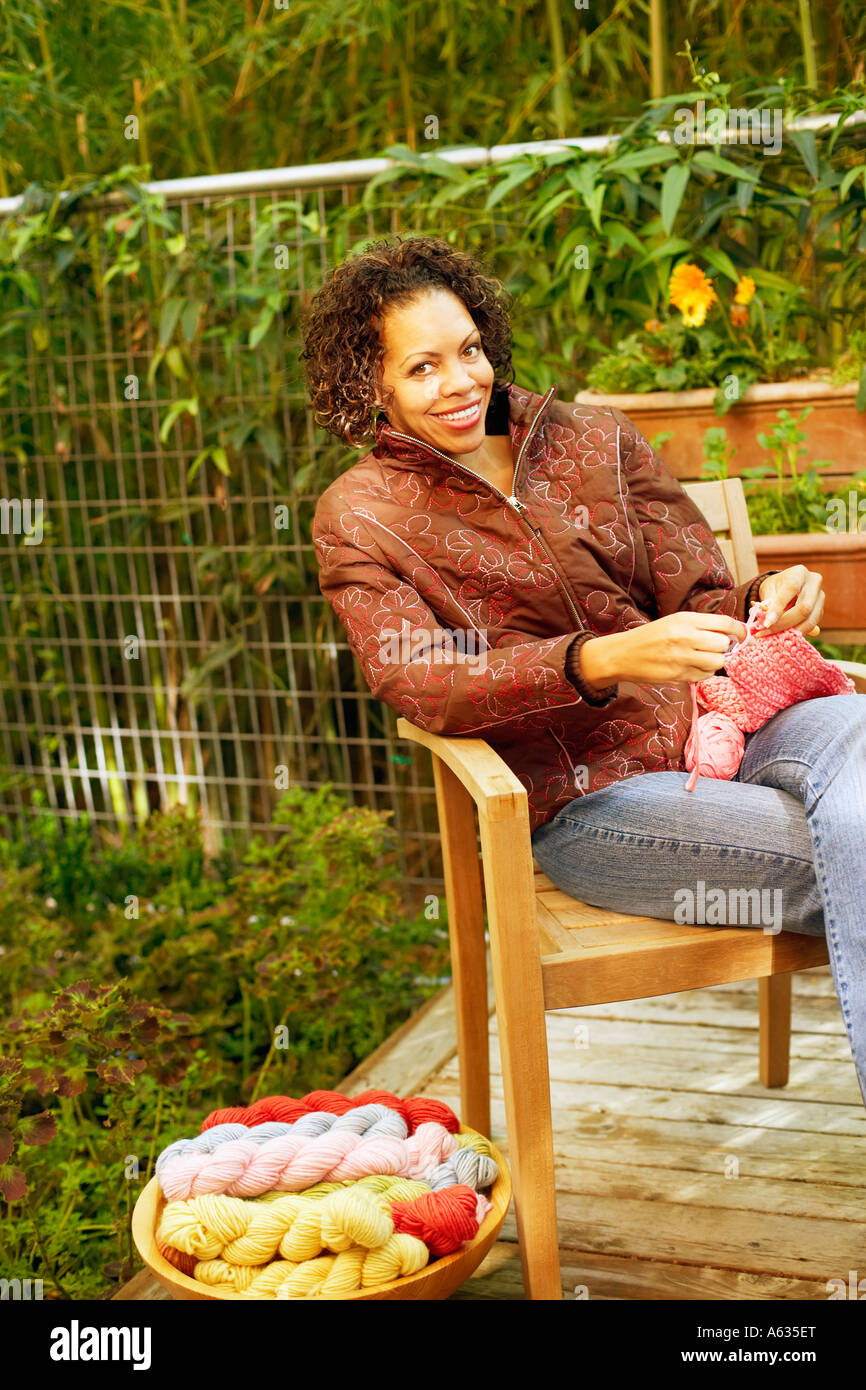 Mature woman knitting and sitting in an armchair Stock Photo - Alamy