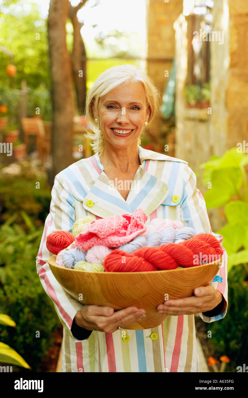 Portrait of a senior woman holding a wicker basket Stock Photo - Alamy