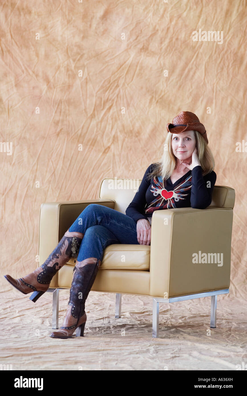 Portrait of a mature woman sitting in an armchair Stock Photo - Alamy
