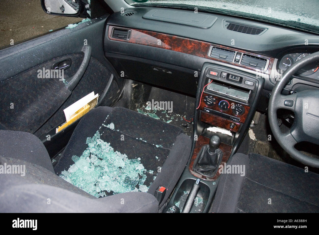 Car which has had a window broken and radio stolen Stock Photo