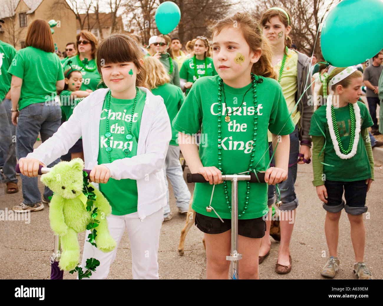 Two parochial school girls participating in St. Patrick's Day parade.  Brookside neighborhood, Kansas City, Missouri, USA. Stock Photo