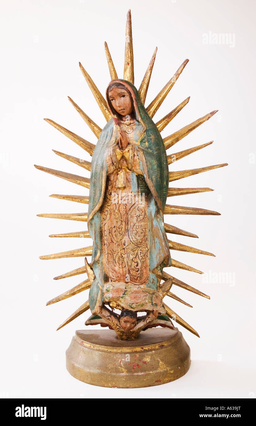 Our Lady of Guadaloupe antique folk art carved-wood statue. Stock Photo