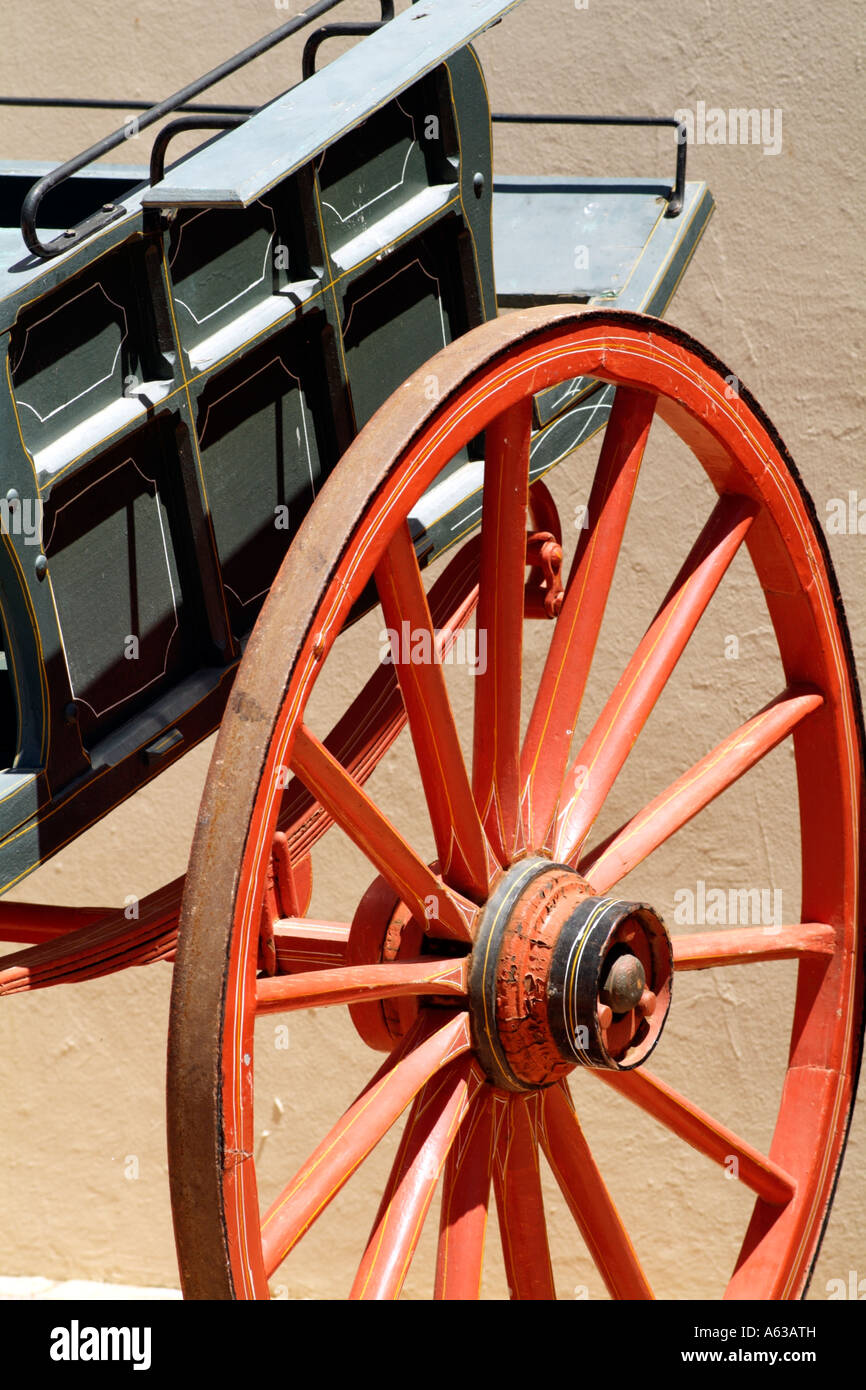 A red cartwheel with wooden spokes and an iron rim Stock Photo